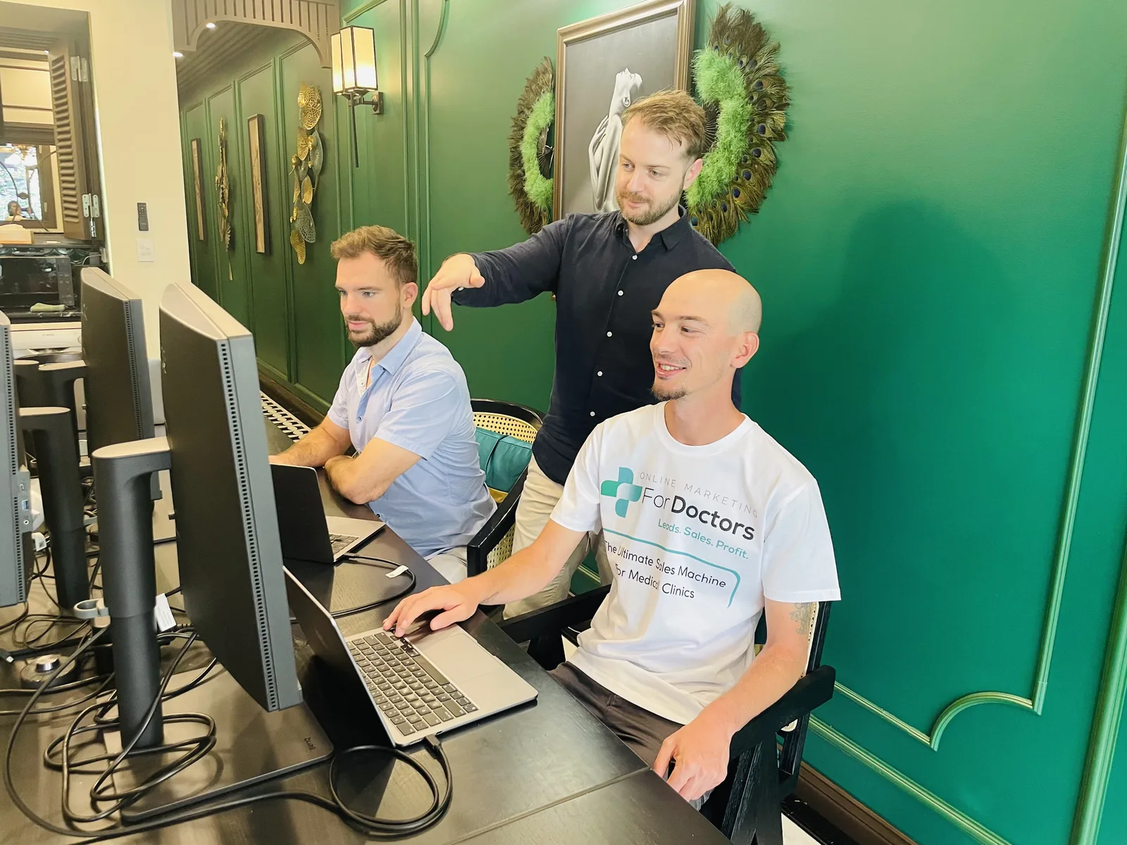 Three of the team reviewing a client account together on screen
