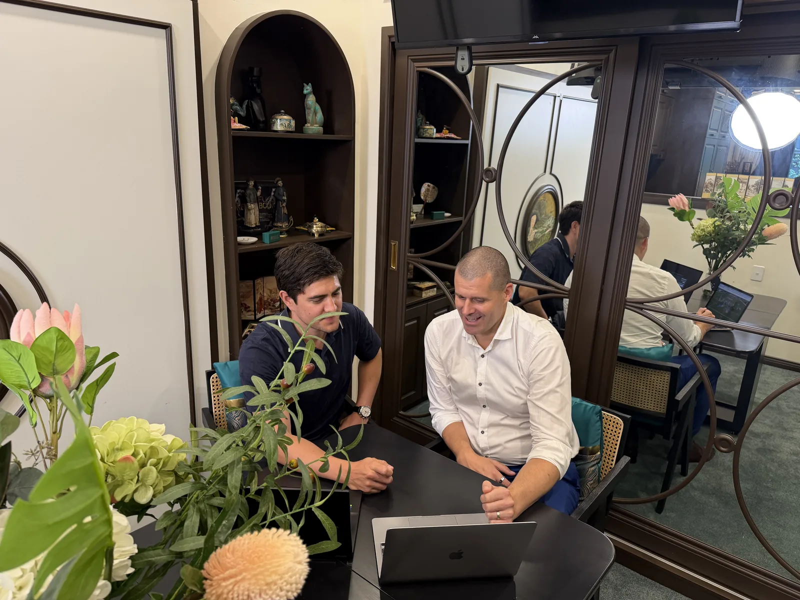 Two of the team talking through results at the office table